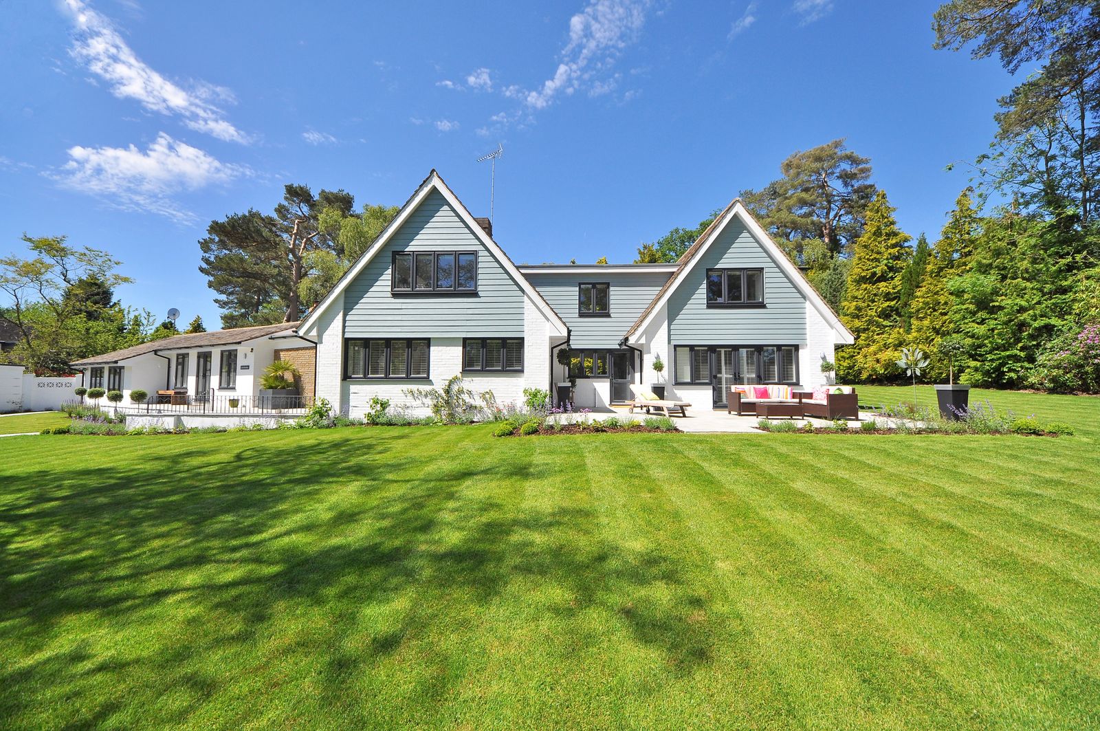A freshly mowed front lawn with crisp edges in front of a brick house
