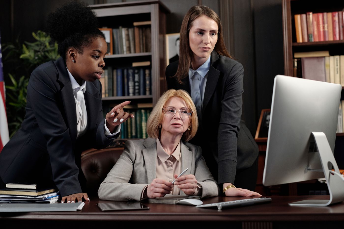 The attorneys of Caldwell & Pierce conferring at a desk in the firm's library