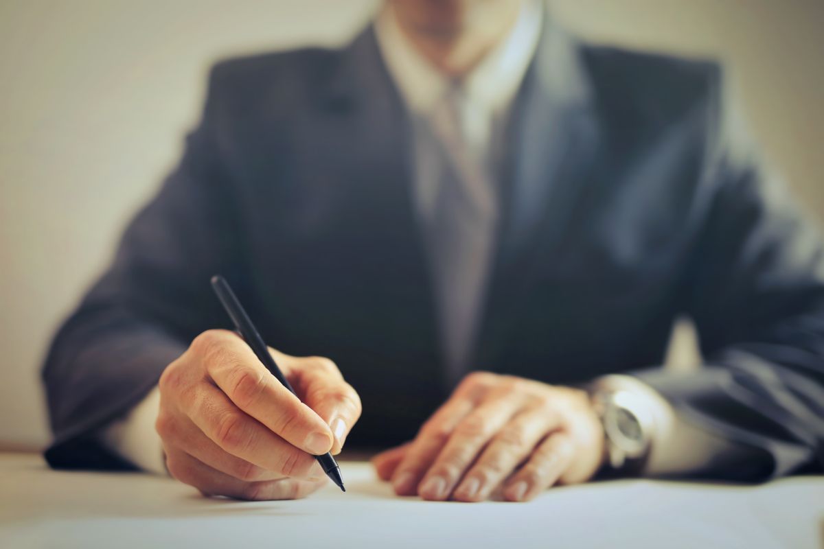 An attorney reviewing and signing documents at the firm