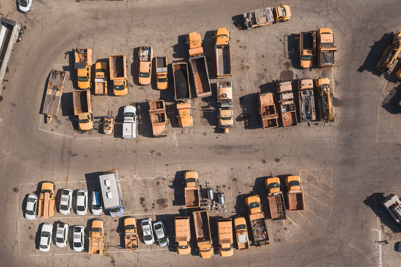 An aerial view of service vehicles in a yard