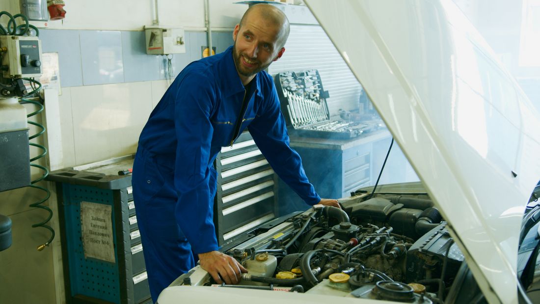 A technician working on an engine