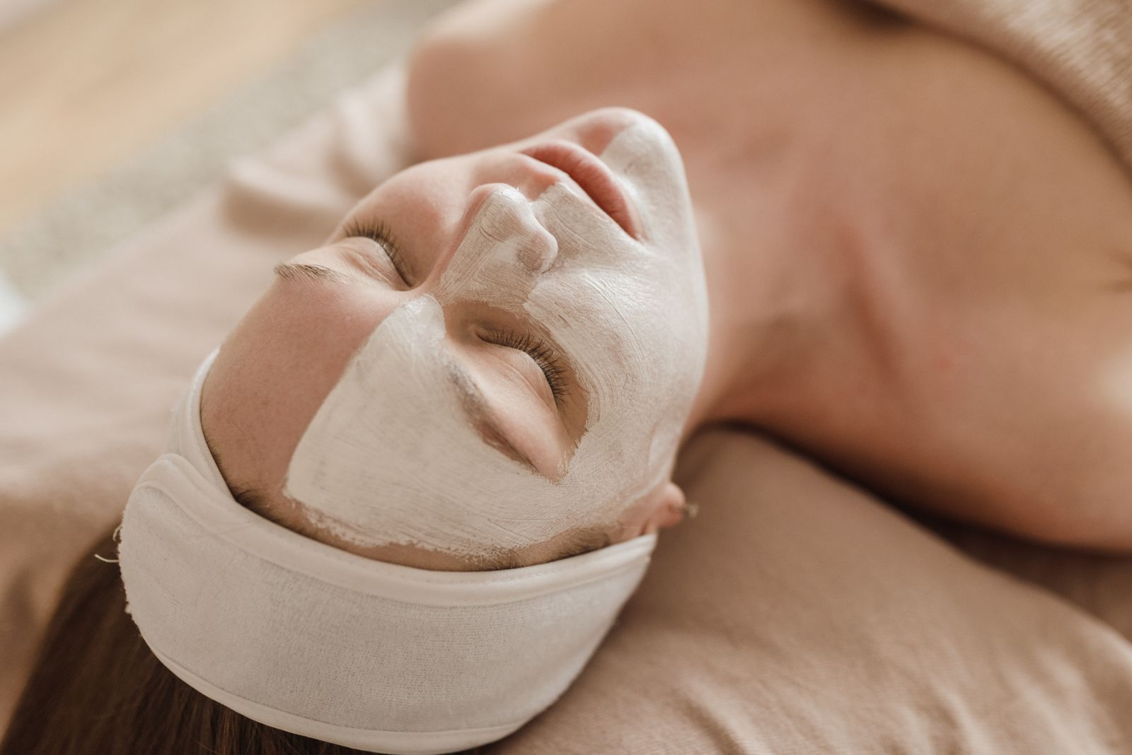 A studio guest resting during a calming facial treatment