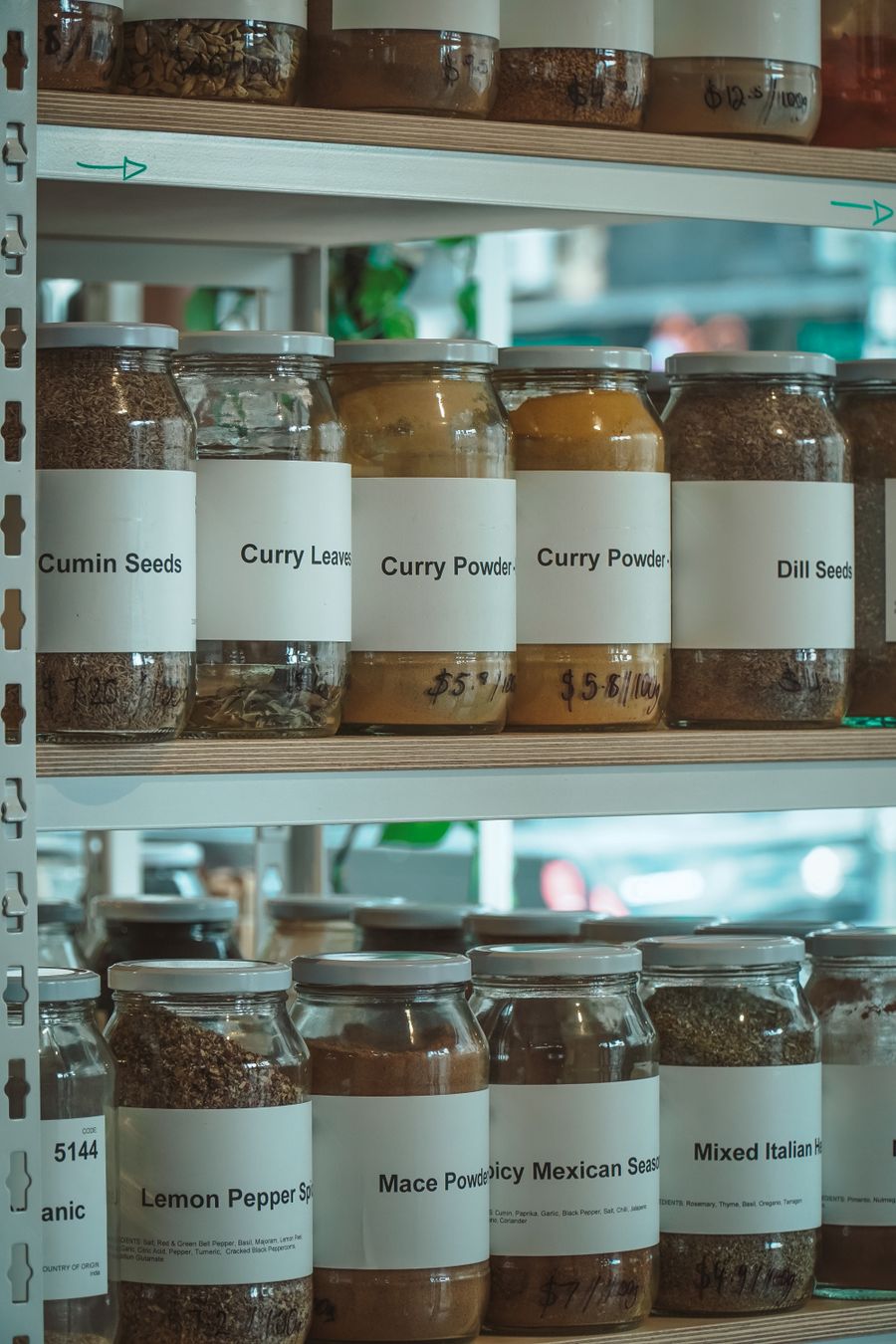 Glass jars of spices lined on a shelf