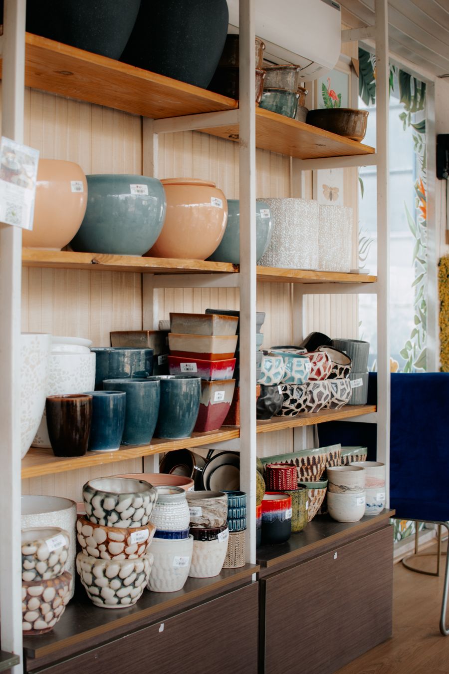 A shelf of colorful vases