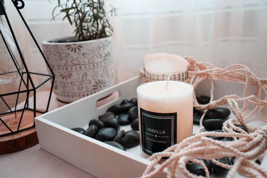 A styled candle and home decor vignette