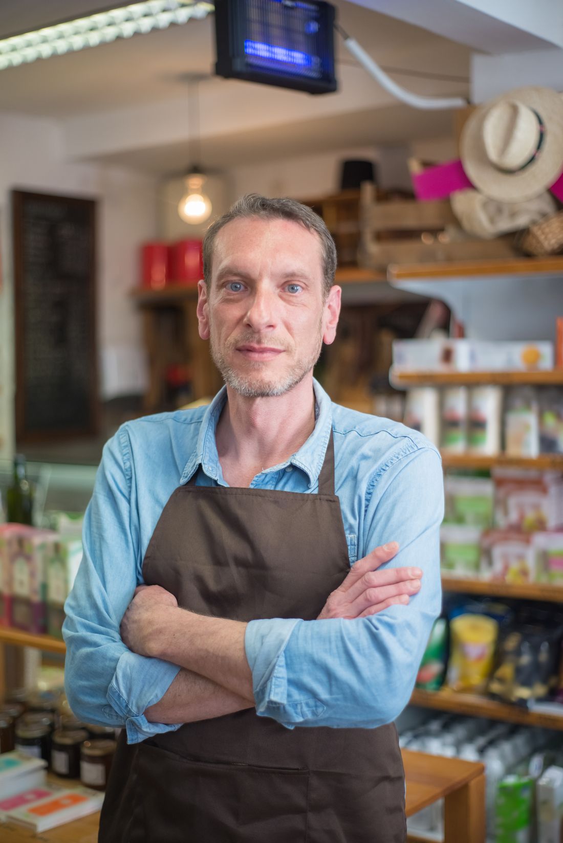 A local maker in an apron inside the shop