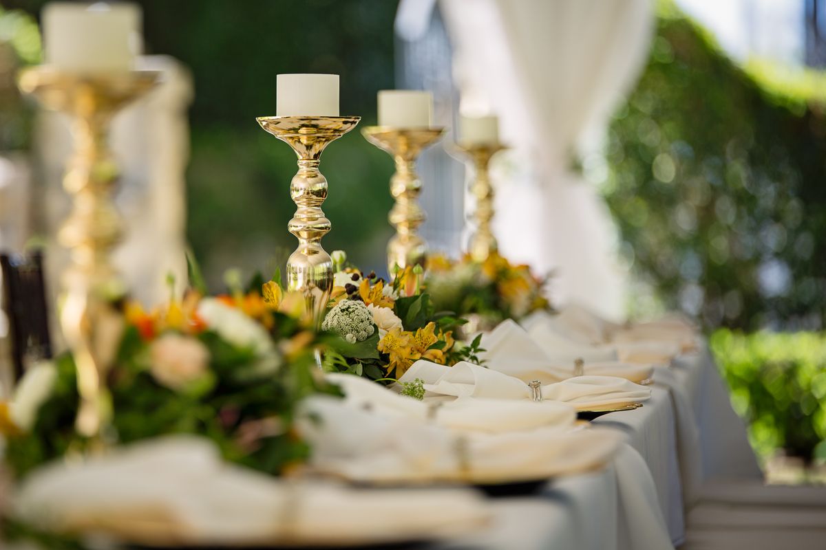 Brass candlesticks on a long dinner table